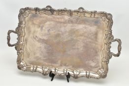 AN EDWARDIAN SILVER TWIN HANDLED TRAY OF RECTANGULAR FORM WITH PIE CRUST AND SHELL RIMS, plain
