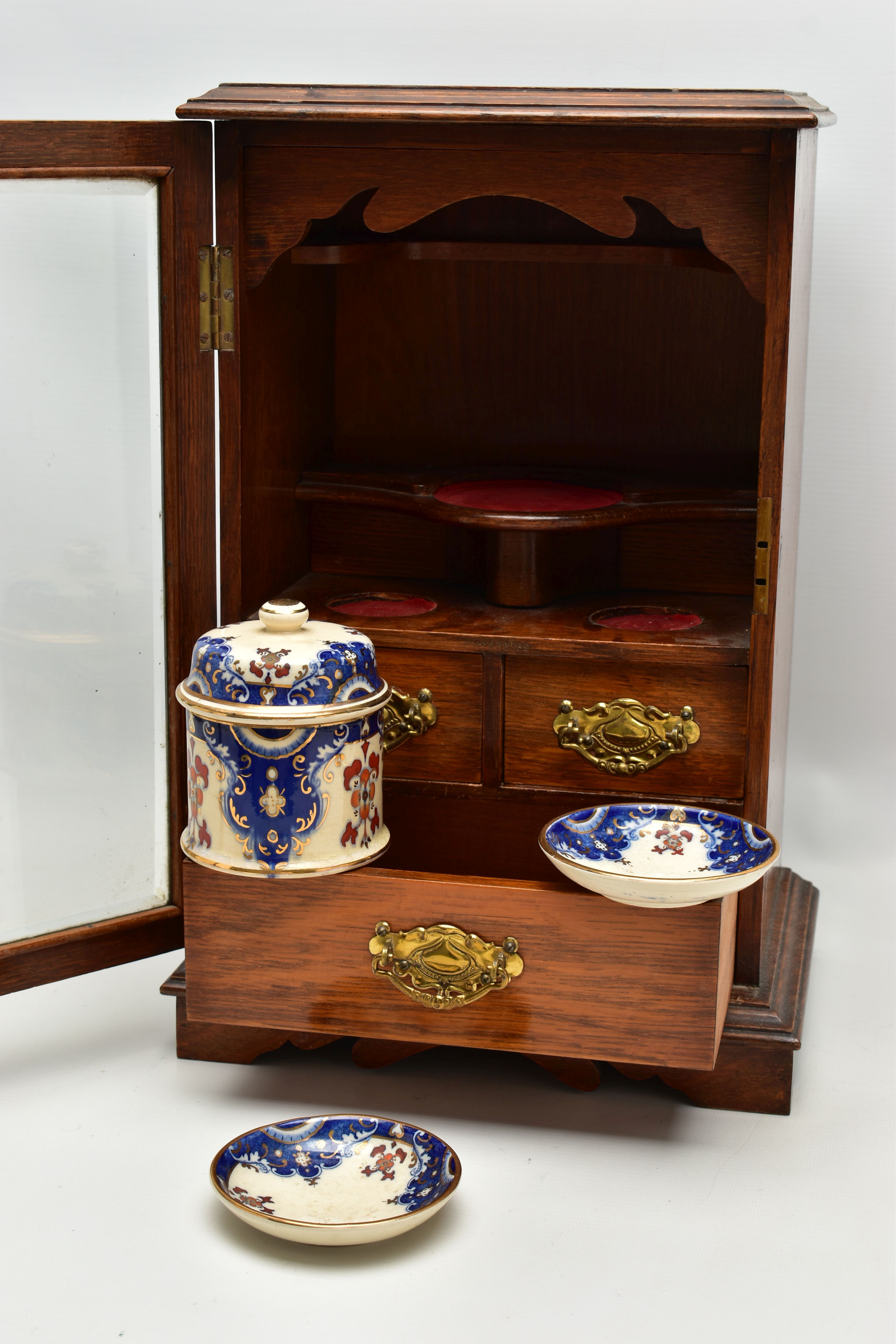 A LATE VICTORIAN OAK CASED SMOKERS CABINET, the bevel edged glazed door opening to reveal a pipe - Image 7 of 11