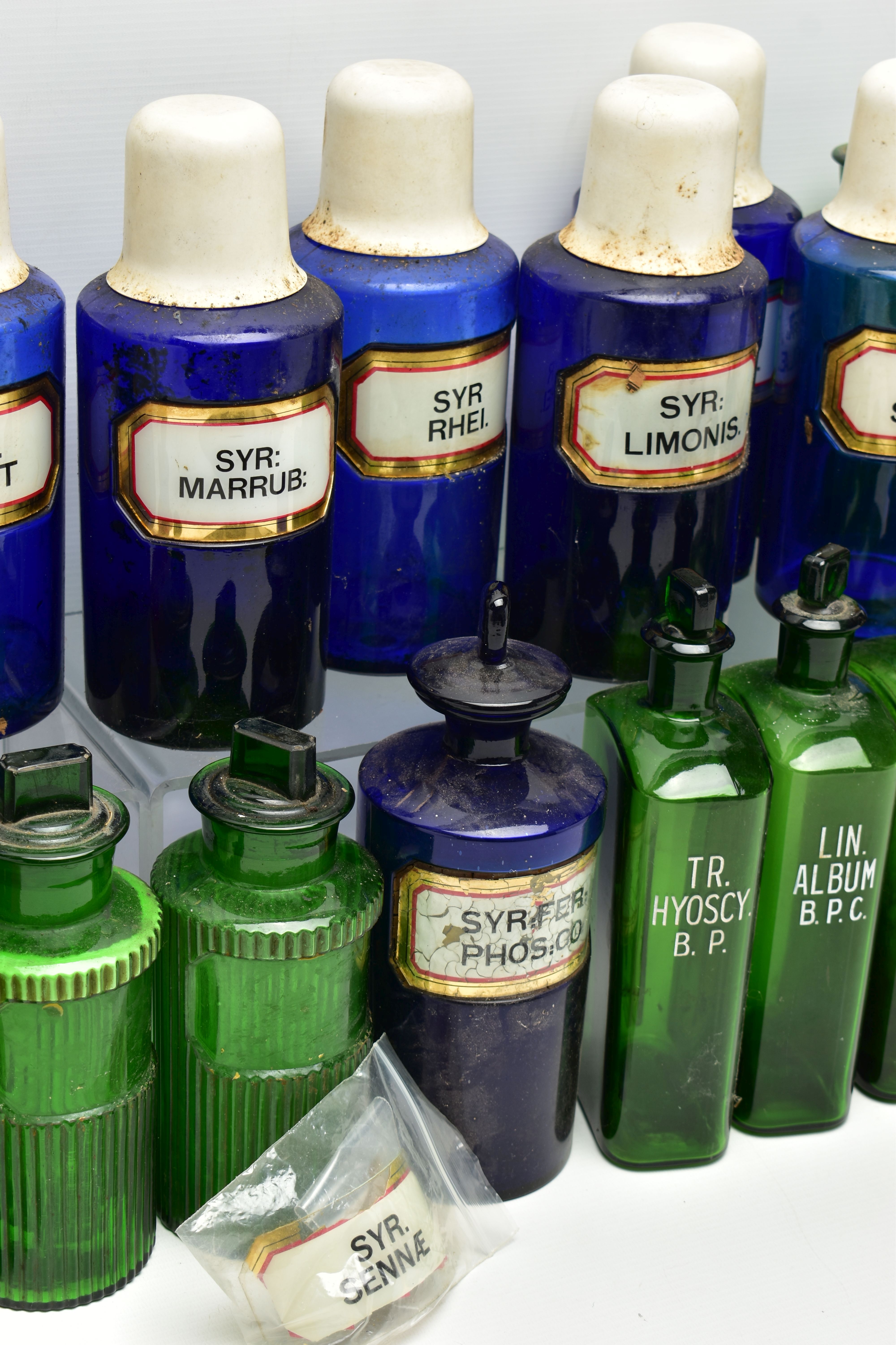 A COLLECTION OF TWENTY THREE COLOURED GLASS PHARMACY BOTTLES, comprising ten blue cylindrical - Image 4 of 5