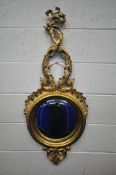 A GILTWOOD ORNATE CONVEX WALL MIRROR, late 20th century, the flowing acanthus leaves above a