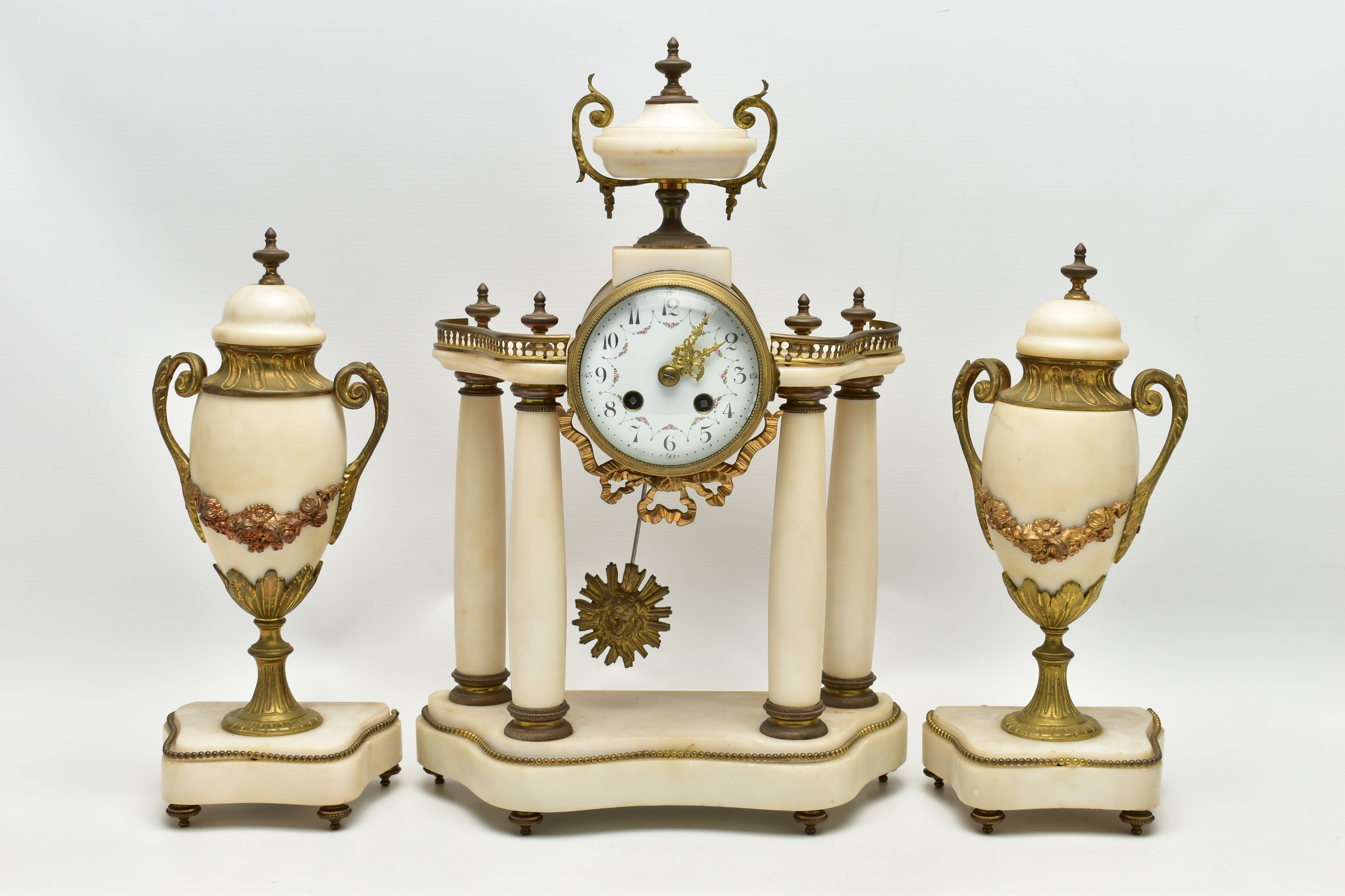 A LATE 19TH CENTURY FRENCH WHITE MARBLE AND GILT METAL CLOCK GARNITURE, the clock with urn