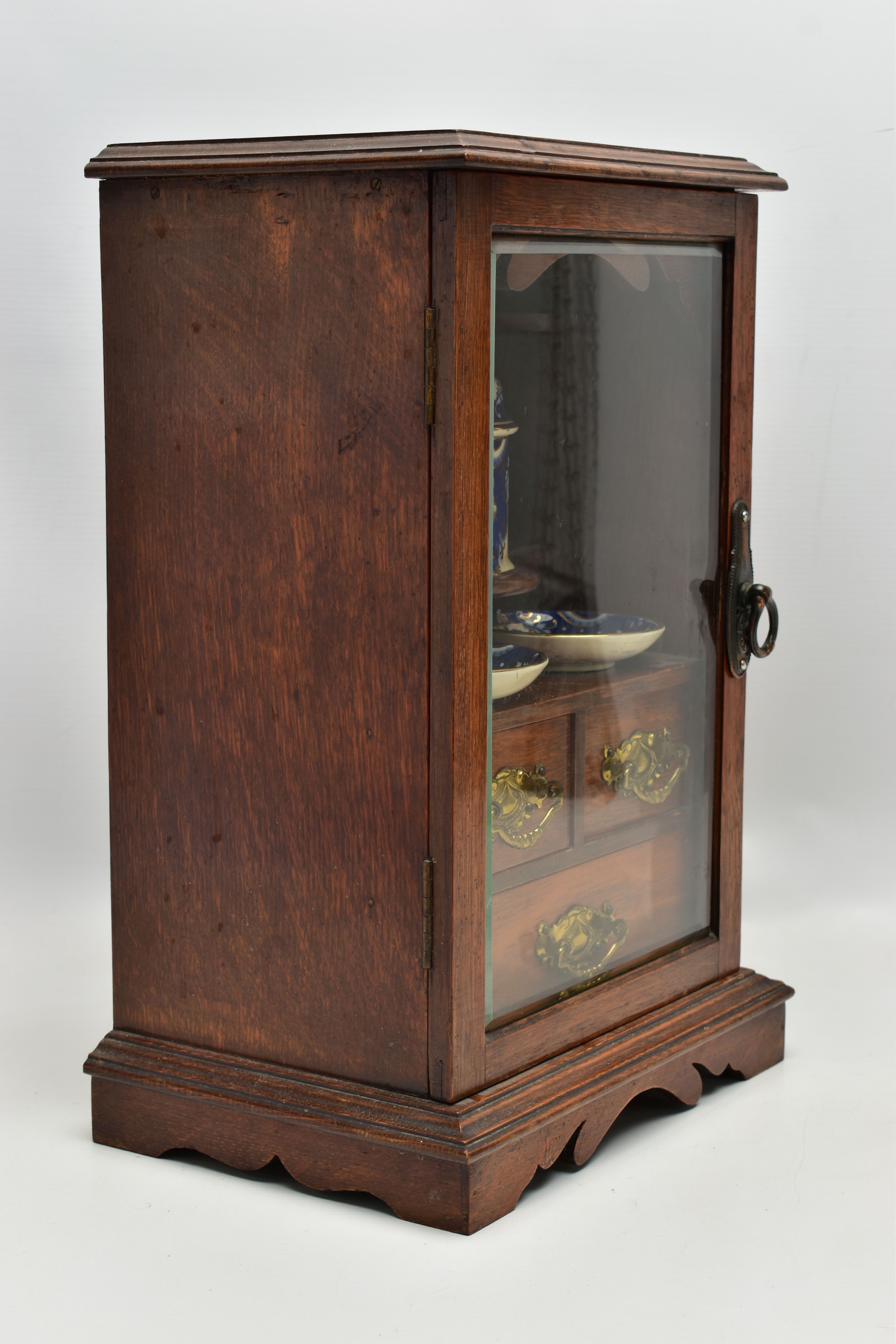 A LATE VICTORIAN OAK CASED SMOKERS CABINET, the bevel edged glazed door opening to reveal a pipe - Image 4 of 11