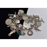 A WHITE METAL CHARM BRACELET, curb link bracelet, links unmarked, fitted with thirty four charms, in