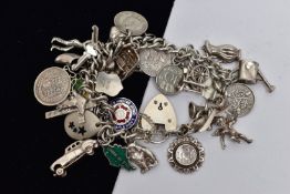 A WHITE METAL CHARM BRACELET, curb link bracelet, links unmarked, fitted with thirty four charms, in
