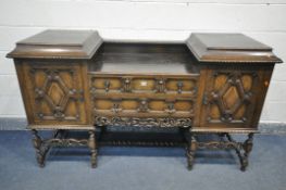 AN EARLY 20TH CENTURY OAK PEDESTAL SIDEBOARD, with geometric doors and drawers, on barley twist legs
