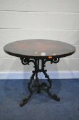 A VICTORIAN STYLE CAST IRON BISTRO TABLE, with a later mahogany top, with a circular plaque,