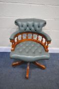 A MINT GREEN LEATHER SWIVEL OFFICE CHAIR, with scrolled back, and turned supports (condition - signs
