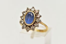 A SAPPHIRE AND DIAMOND CLUSTER RING, oval cut blue sapphire set within a yellow gold bezel mount,