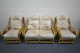 A WICKER THREE PIECE CONSERVATORY SUITE, comprising a two seater sofa, length 130cm, and two