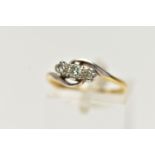 A YELLOW METAL THREE STONE DIAMOND RING, designed with a central claw set, round brilliant cut