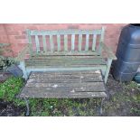 A WOODEN GARDEN BENCH along with a small wooden slatted table/bench with cast aluminium ends (2)
