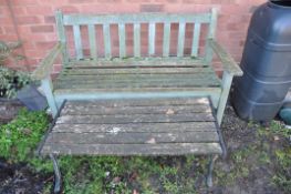 A WOODEN GARDEN BENCH along with a small wooden slatted table/bench with cast aluminium ends (2)