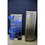 A SET OF METAL DRAWS with fifteen draws along with a wall mounted storage with sixteen blue