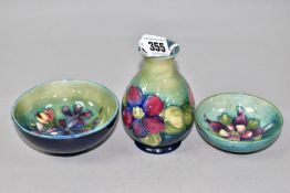 THREE PIECES OF MOORCROFT POTTERY, comprising a Clematis pattern vase height 11cm, a Spring