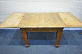 AN ARTS AND CRAFTS PINE DRAW LEAF DINING TABLE, on square tapered legs, extended length 193cm x