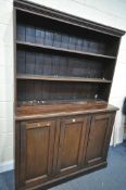 A 19TH CENTURY PAINTED PINE BOOKCASE, the open shelving top, above a base with triple panelled