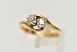 A TWO STONE DIAMOND CROSSOVER RING, two old cut diamonds each within eight claw settings within a