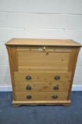 A MODERN PINE BUREAU, with a fall front door, enclosing a fitted interior, above three drawers, on