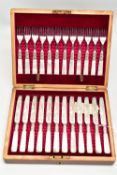 A CASED SET OF TWELVE DESSERT KNIVES AND FORKS, each EPNS blade is decorated with a floral