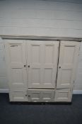 A 19TH CENTURY PAINTED PINE HOUSEKEEPERS CUPBOARD, with three panelled cupboard doors, enclosing