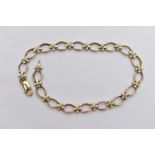 A 9CT GOLD DIAMOND BRACELET, designed with a series of oval openwork links, interspaced with cross