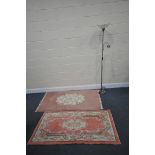 A PINK RECTANGULAR RUG, with central floral design, 154cm x 92cm, another rug, and a standard