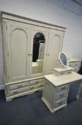 A GOOD QUALITY CREAM FRENCH BEDROOM SUITE, comprising a triple door wardrobe, above five drawers,