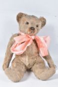 A WELL LOVED GOLDEN PLUSH TEDDY BEAR, original amber and black glass eyes (one loose), remains of