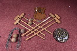 A CROQUET SET, with six wooden mallets, six metal hoops, two wooden pegs and four wooden balls, in