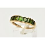 A 9CT GOLD GEM SET RING, designed with a row of channel set, graduating square cut green