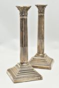 A PAIR OF GEORGE V SILVER CORINTHIAN COLUMN CANDLESTICKS, fluted and stop reeded columns on