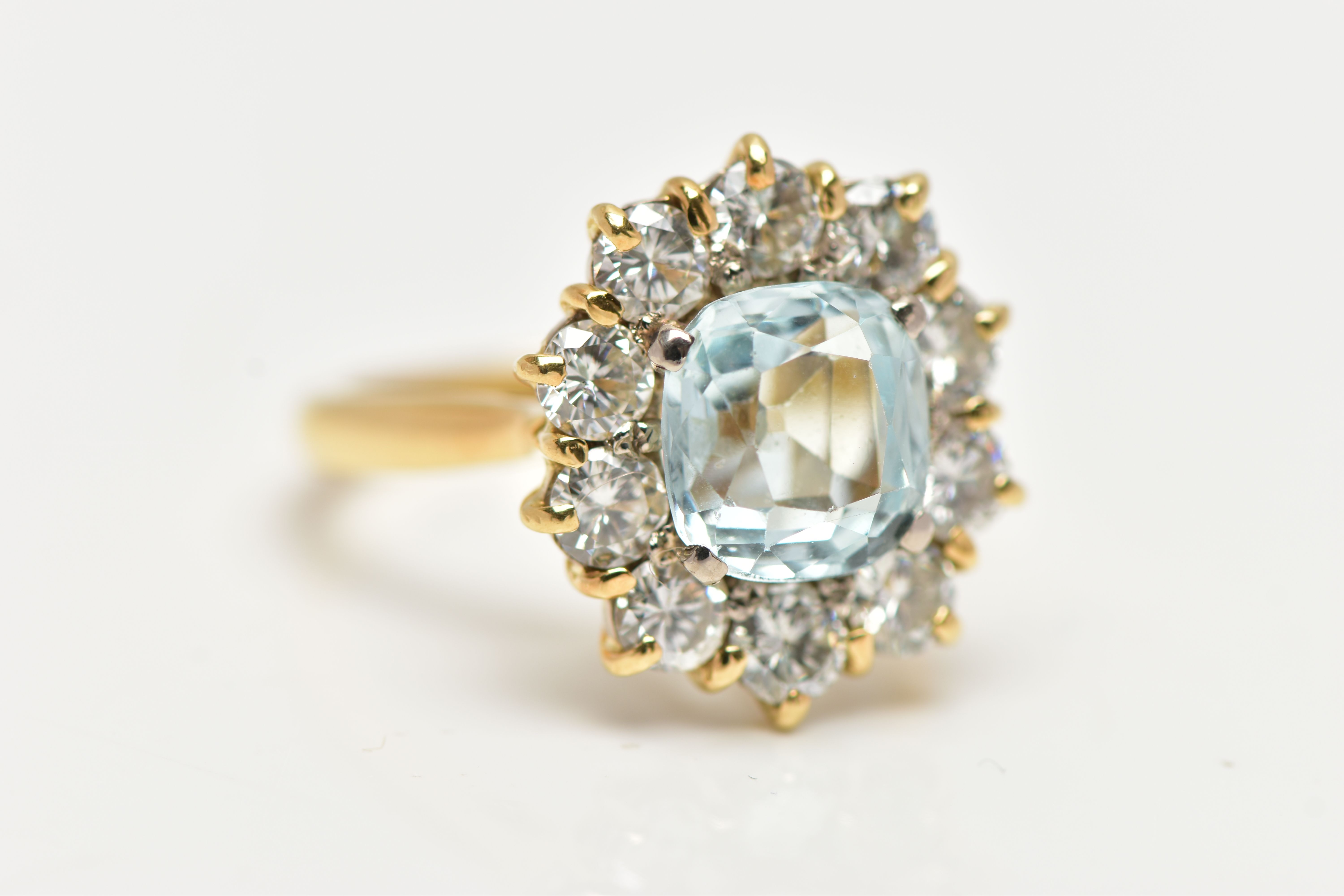 A YELLOW METAL AQUAMARINE AND DIAMOND CLUSTER RING, centring on a four claw set, cushion cut - Image 6 of 7