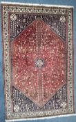 A 20TH CENTURY IRANIAN ABADEH RUG, typical design with a central medallion, with a central red field