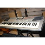 A CASIOTONE 7000 ELECTRONIC KEYBOARD and a Roland EM15 electronic keyboard and two stands ( no power