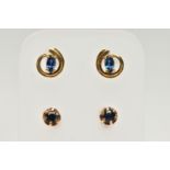 TWO PAIRS OF SAPPHIRE SET EARRINGS, the first pair of an openwork swirl design, centrally set with a