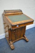 A LATE VICTORIAN WALNUT AND MARQUETRY INLAID DAVENPORT, with a pierced brass gallery, a green