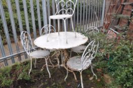 A WHITE PAINTED METAL GARDEN TABLE 100cm in diameter with scrolled tubular legs and five similar