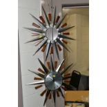 FOUR MID-CENTURY SUNBURST WALL CLOCKS, and a teak and chrome sunburst clock frame (one ray tip