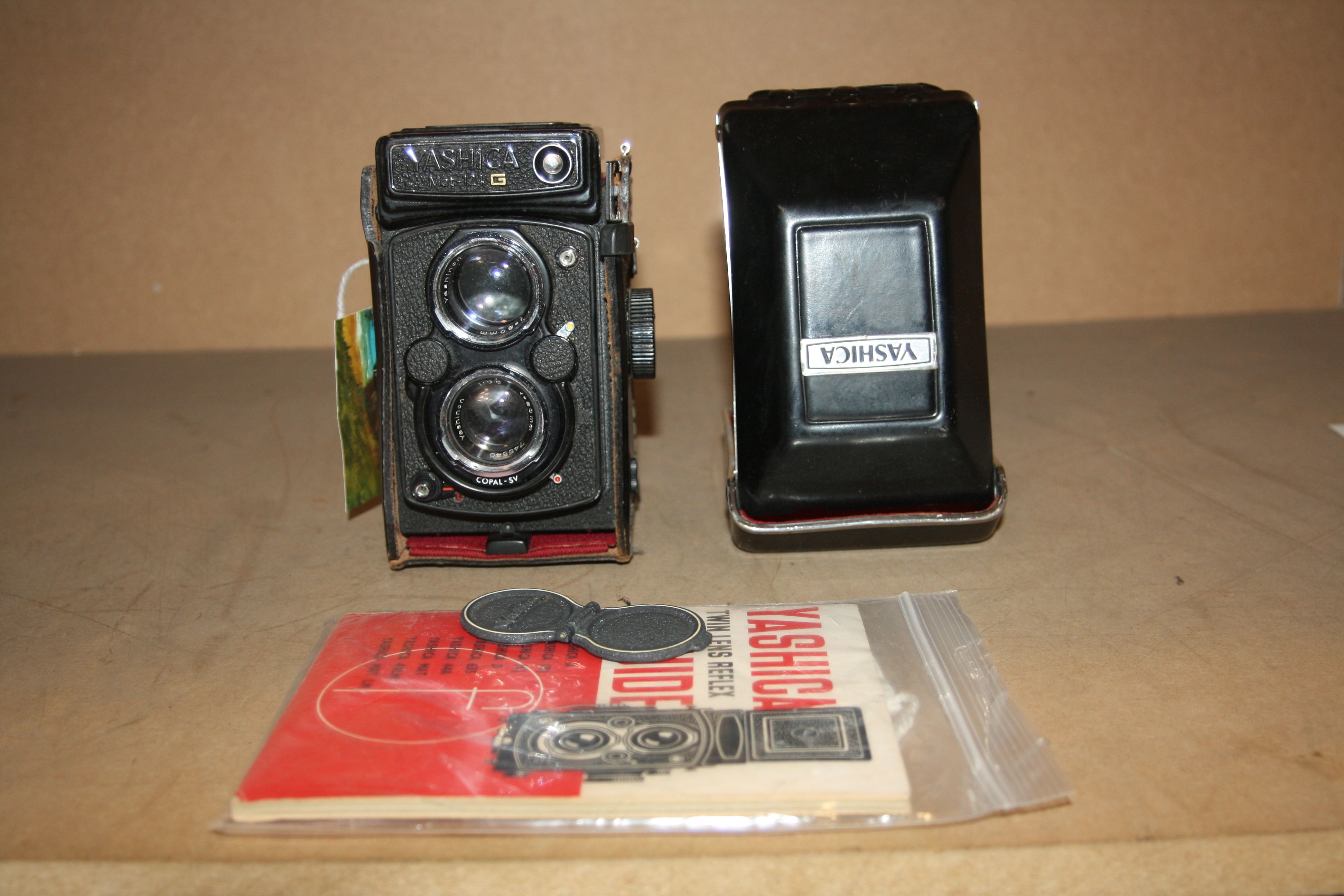 A YASHICA MAT 124G TLR CAMERA with 80mm f 2.8 and f3.5 lenses and leather case along with Yahica