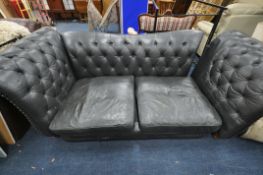 A LARGE BLACK CHESTERFIELD SOFA, approximate width 241cm x depth 140cm x height 92cm (condition:-