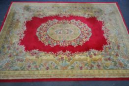 A RED AND GOLD GROUND CHINESE RUG, 271cm x 182cm (condition:-stained and dirty) along with a five