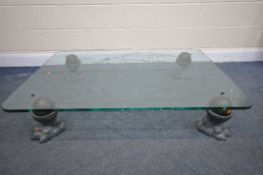 A HEAVY BESPOKE COFFEE TABLE, with etched glass top of crest, on four lead claw shaped feet with