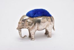 AN EDWARDIAN SILVER PIN CUSHION IN THE FORM OF A STANDING ELEPHANT, makers Adie & Lovekin Ltd,