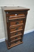A STAINED HARDWOOD TALL CHEST OF DRAWERS, with a hinged lid, enclosing a fitted drawer, mirror and