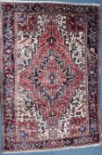 A 20TH CENTURY IRANIAN HERIZ RUG, typical design with a central medallion, 332cm x 230cm (