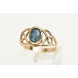 A YELLOW METAL GEMSET RING, a opal triplet collet set in an open work Celtic design yellow metal