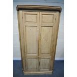 A LARGE VICTORIAN PINE PANELLED FOUR DOOR CORNER CUPBOARD, enclosing a blue painted interior, and