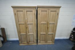 A PAIR OF 19TH CENTURY AND LATER PINE PANELLED SCHOOL CUPBOARDS, each having double doors that's