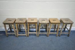 A SET OF SIX LATE 19TH EARLY 20TH CENTURY BEECH SCHOOL LABORATORY STOOLS, 34cm squared x height 56cm
