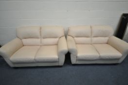 A PAIR OF CREAM LEATHERETTE TWO SEATER SOFAS, length 155cm (condition - signs of wear and dirt)